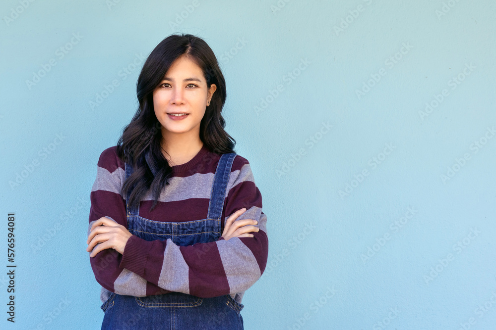 happy young woman posing isolated over blue wall background happy young woman posing isolated over blue wall background