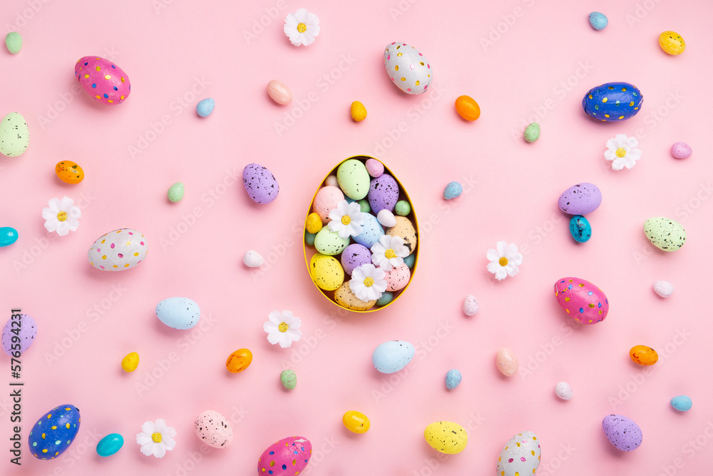 Easter Eggs with Sweets and Spring Flowers on Pink Background Easter Eggs with Sweets and Spring Flowers on Pink Background