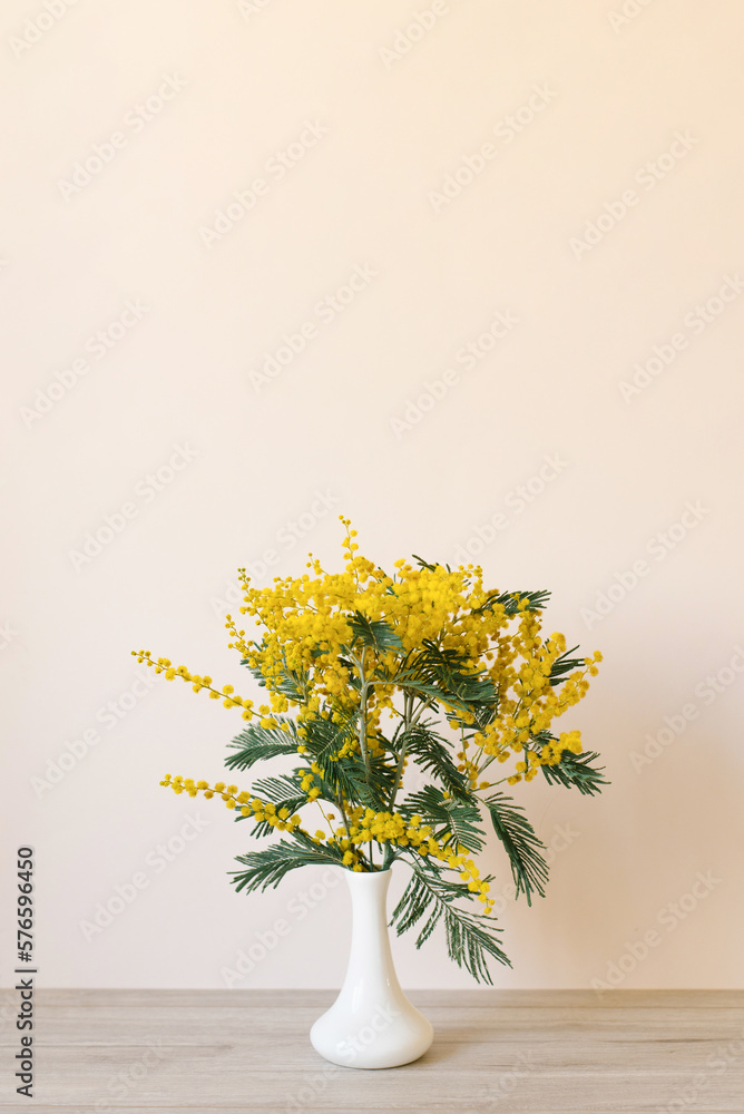 Bouquet of yellow mimosa flowers in a vase. Concept of women's or mother's day Bouquet of yellow mimosa flowers in a vase. Concept of women's or mother's day