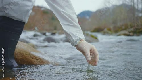 Scientist takes samples dirty water test,Explorers work test tube close up