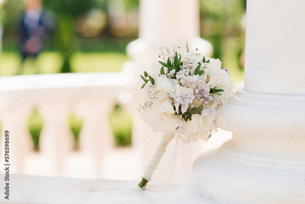 Delicate wedding bouquet with white hydrangea and greenery close-up