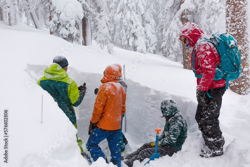 Students digging in snow pit during avalanche course with Colorado Mountain School, Rock Mountain National Park, Colorado, USA
