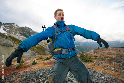 Front view of hiker fighting with wind photo