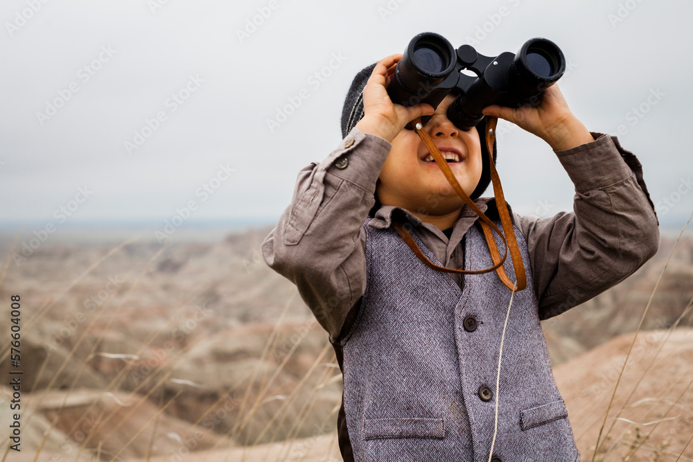 Boy wearing explorer costume holding binoculars Boy wearing explorer costume holding binoculars