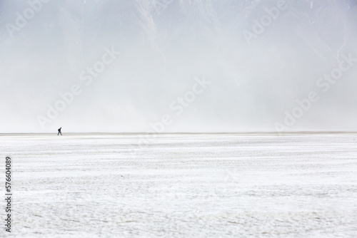 Lone hiker walking through dust storm, Kluane National Park, Yukon, Canada