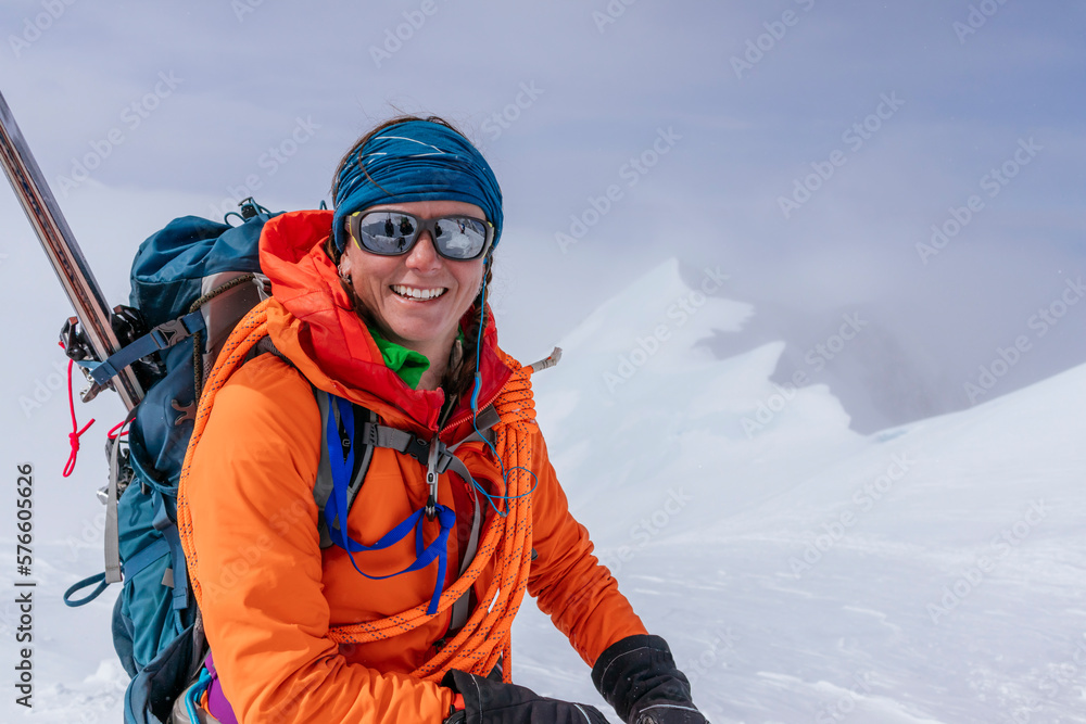 Female mountaineer smiling at camera while climbing Denali, Denali National Park, Alaska, USA Female mountaineer smiling at camera while climbing Denali, Denali National Park, Alaska, USA