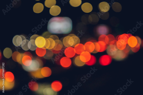 Abstract bokeh background and texture of a night street with cars and street lamps. City life, defocused city skyline lights. Abstract background for design. copy space