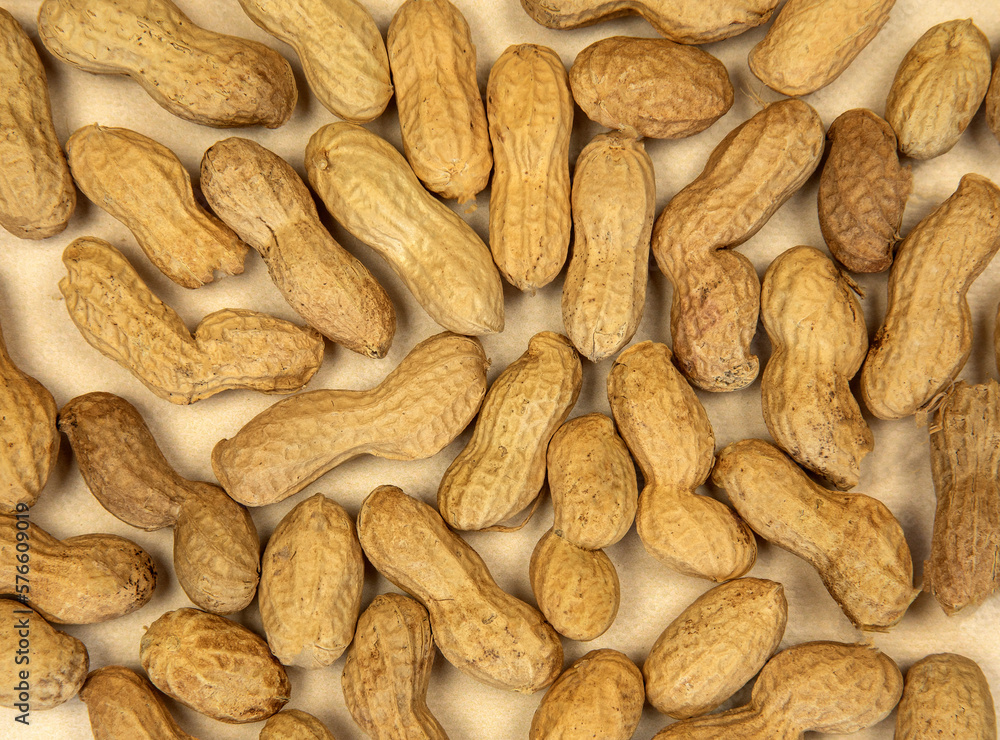 Peanuts in the shell roasted peanuts stacked up top view, background texture healthy natural food concept Peanuts in the shell roasted peanuts stacked up top view, background texture healthy natural food concept