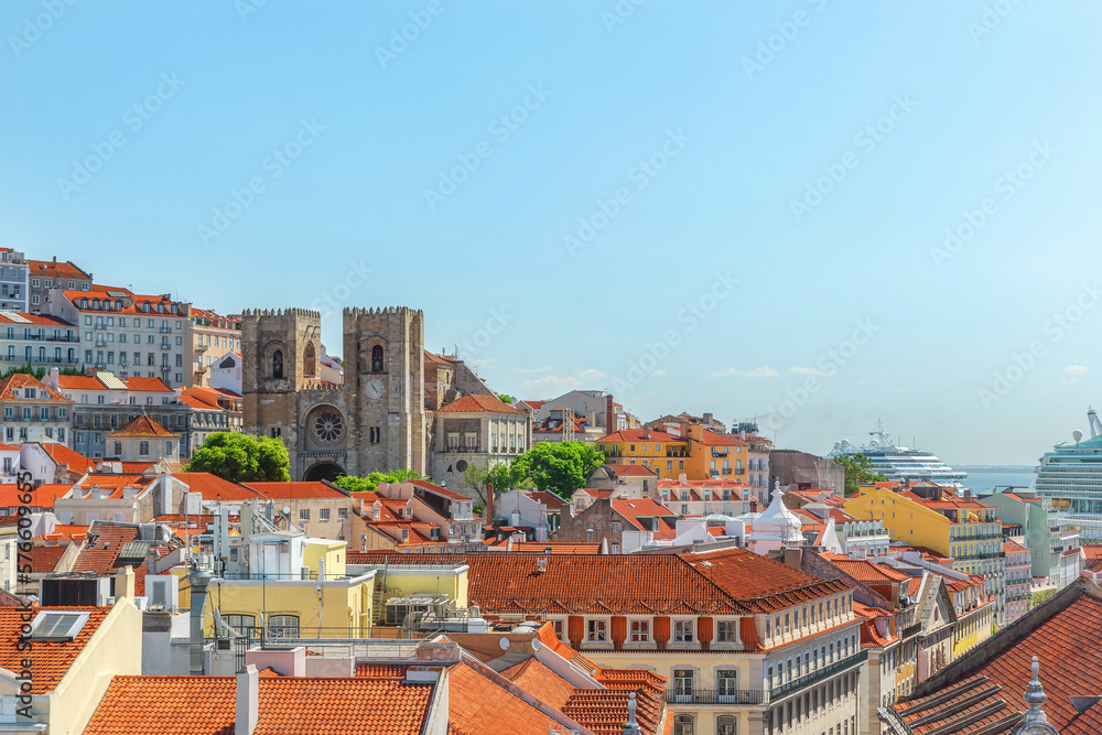 Aerial view of old town of Lisbon, Portugal on Tagus river with cathedral and orange rooftops