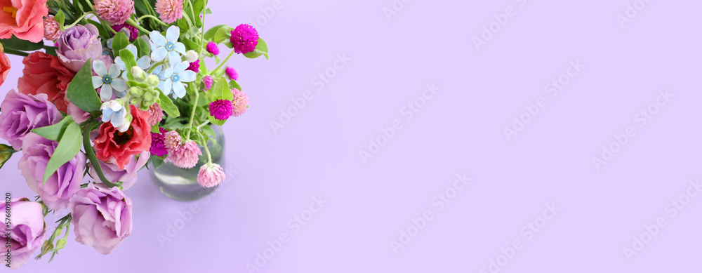 Top view image of pink and purple flowers composition over pastel background
