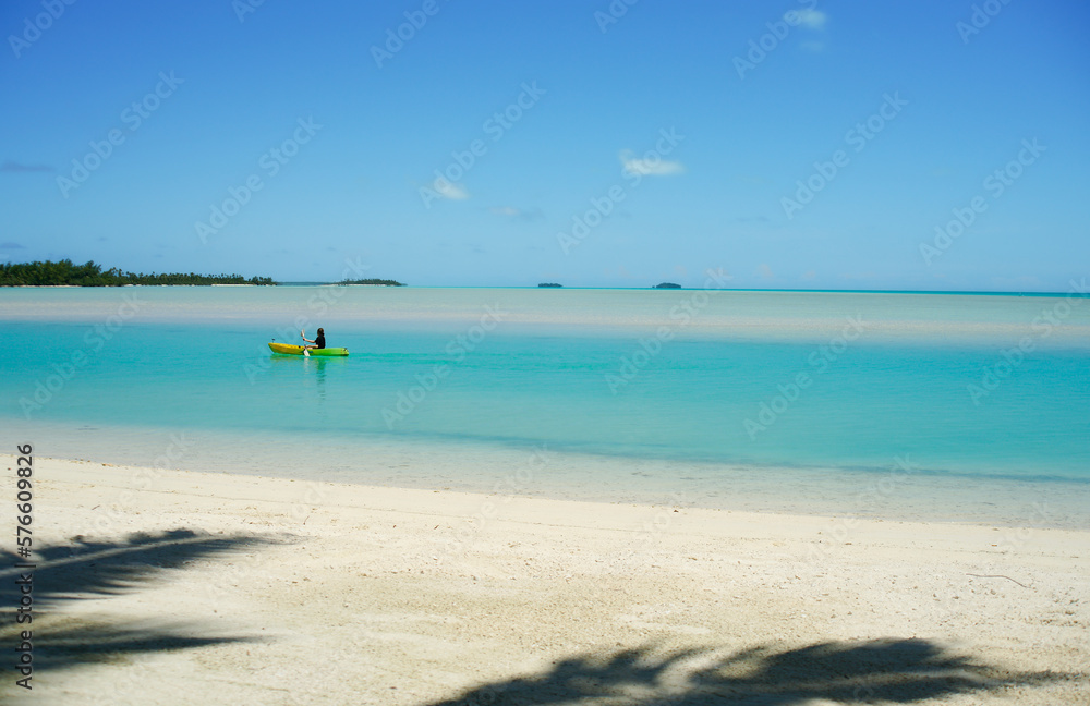 Kayaker paddles along in idyllic tropical lagoon