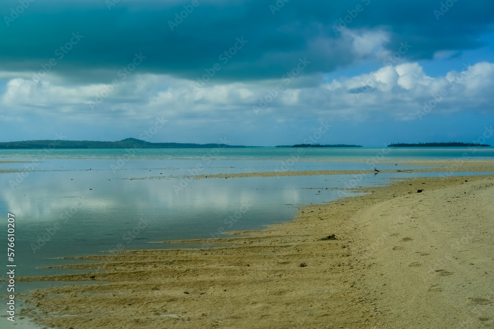 Sun illuminated beach below dark storm clouds . Sun illuminated beach below dark storm clouds .