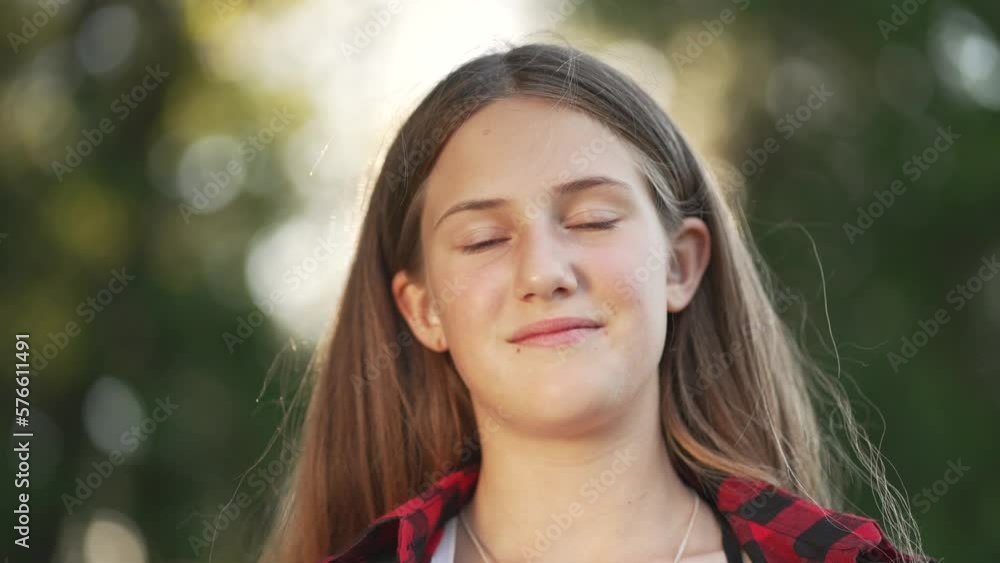 Happy girl in park at sunset. Portrait of young girl. Children fashion smile child. Fashion dream. Cheerful smile of child. Happy girl portrait outdoors in sun. Dreamy face of child. fashion concept Happy girl in park at sunset. Portrait of young girl. Children fashion smile child. Fashion dream. Cheerful smile of child. Happy girl portrait outdoors in sun. Dreamy face of child. fashion concept
