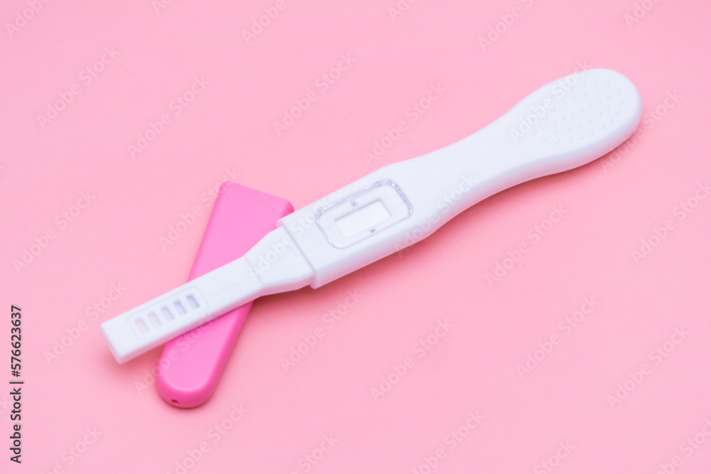 Opened pregnancy test isolated on the pink background. Opened pregnancy test isolated on the pink background.