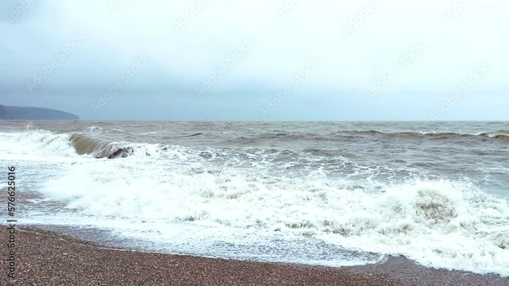 Powerful sea waves are crashing on the Black Sea coast. Waves splash on the beach with pebbles during a storm. Storm at sea. Panoramic view of the Black Sea. Russia. Sunset on the beach. 4K Powerful sea waves are crashing on the Black Sea coast. Waves splash on the beach with pebbles during a storm. Storm at sea. Panoramic view of the Black Sea. Russia. Sunset on the beach. 4K