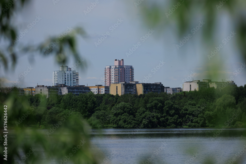 Buildings and houses standing on the shore of a lake, river or sea.
Cityscape and urban scene.