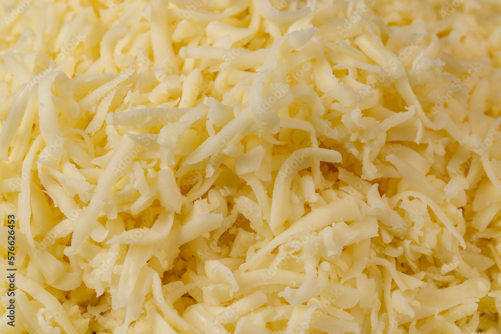 Hard cheese with holes grated into thin small slices Hard cheese with holes grated into thin small slices