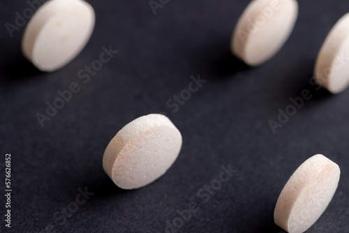 White and yellow medical medicines on a black background