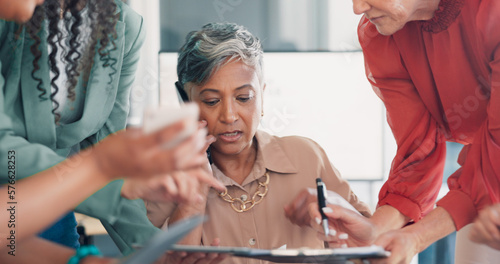 Business, woman and multitasking with stress, phone call or deadline for project, team and office. Female employee, mature lady overworked or manager busy with smartphone, corporate deal or burnout photo