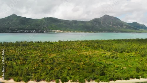 Panning shot of the Ile Aux Benitiers in Mauritius with mountains in the background  photo