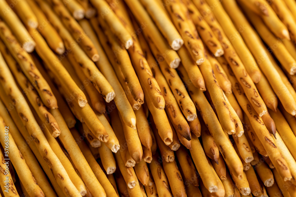 Thin and long bread sticks made of wheat flour on the table