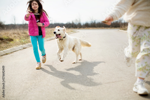Kids running with the dog