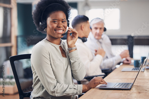 Portrait, customer service and laptop with a black woman consultant working in her telesales office. Contact us, support and call center with a happy female employee consulting using a headset photo