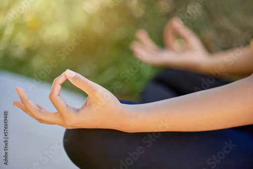 Closeup, hands and woman in yoga, lotus and pose while training in nature for wellness, relax and zen. Zoom, hand and exercise by girl in meditation, chakra and energy balance, mindfulness or healing