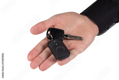 A businessman holding a car key on isolated background
