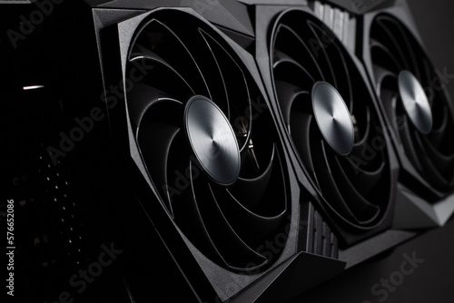 video card with three coolers from the computer on a dark background.concept computer harware. photo