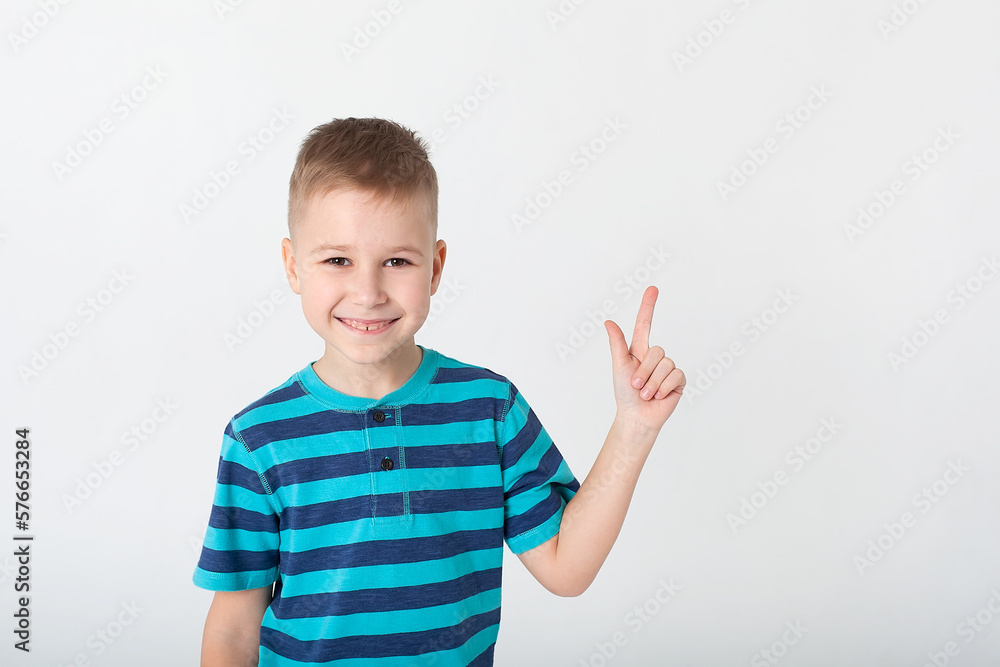 The winning child, highlighted on a white background, will show his emotions. Isolated on a white background. The winning child, highlighted on a white background, will show his emotions. Isolated on a white background.