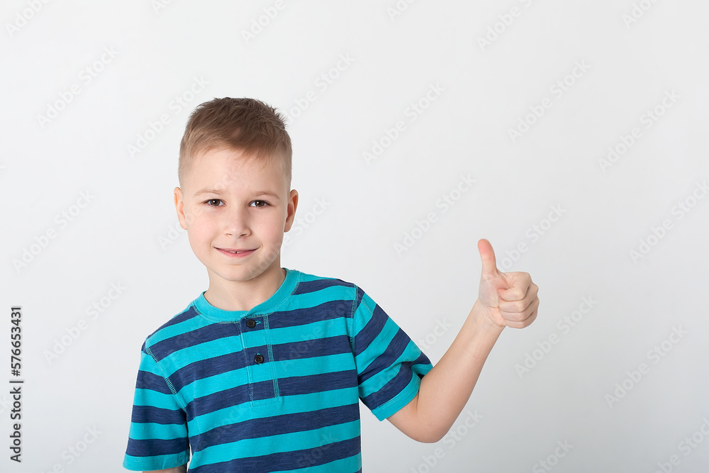 Portrait of beautiful little boy giving you thumbs up over yellow background. Portrait of beautiful little boy giving you thumbs up over yellow background.