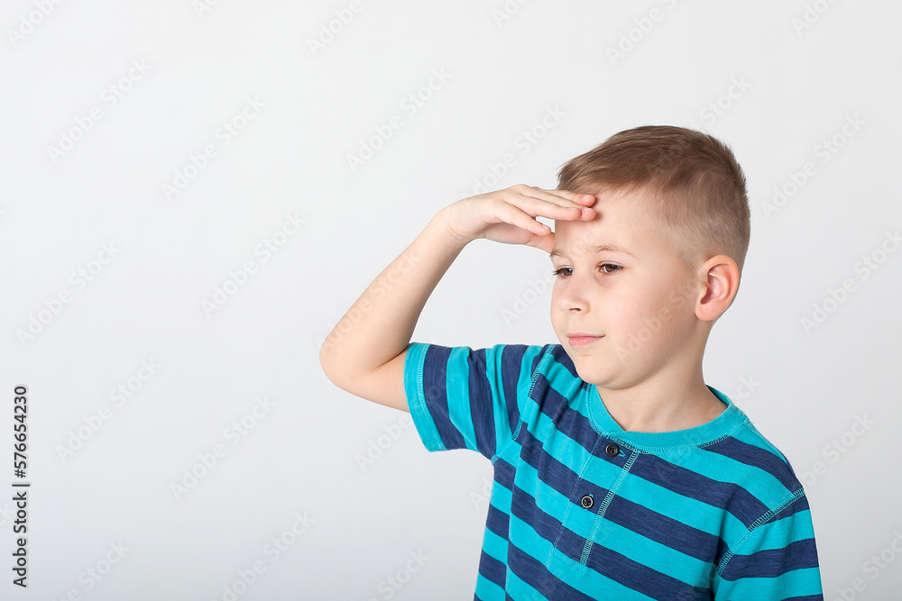 handsome boy looks angry. The child is offended, threatens, shows a fist. Angry, resentful, aggressive child. Portrait on white studio background. Children's human emotions concept. handsome boy looks angry. The child is offended, threatens, shows a fist. Angry, resentful, aggressive child. Portrait on white studio background. Children's human emotions concept.
