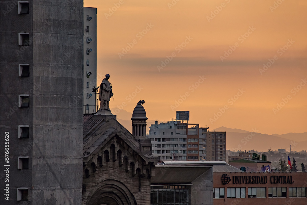 Fototapeta premium Bright sunset in Santiago Chile. Cityscape with sunset sky. Central University in Santiago