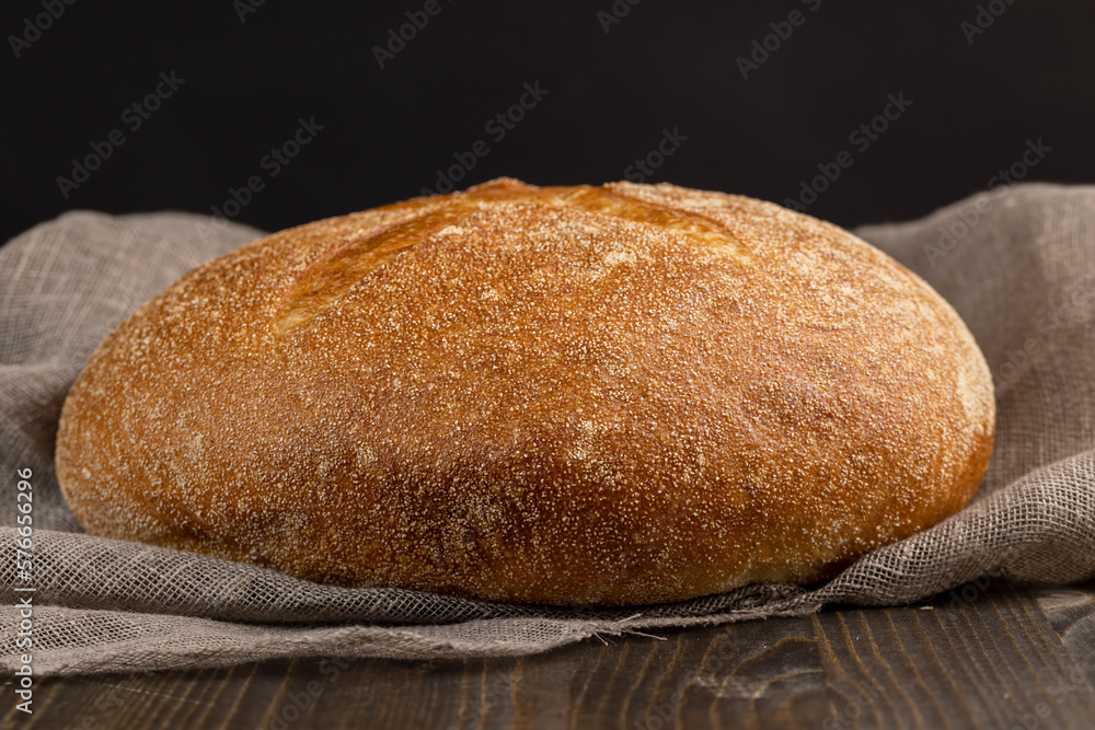 A whole loaf of round-shaped wheat bread