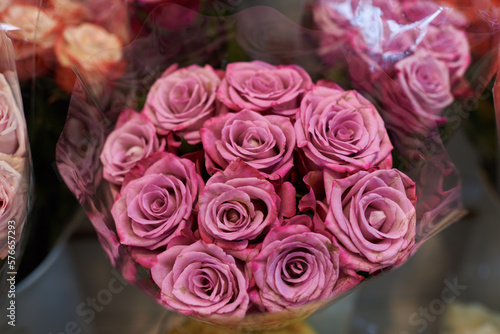 Beautiful bouquets of pink roses in a flower shop. A bright mix of flowers. Handsome fresh bouquets. Flowers delivery. Floral shop. Selective focus.