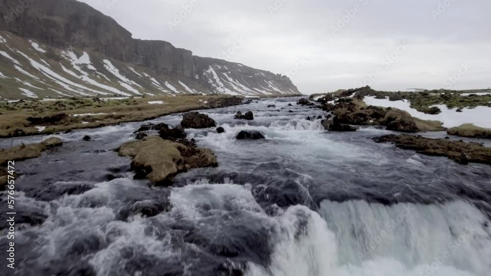 Winter landscape in Iceland with river and waterfall through the countryside Winter landscape in Iceland with river and waterfall through the countryside