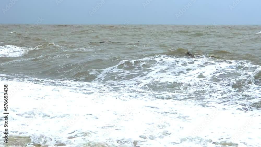Powerful sea waves are crashing on the Black Sea coast. Waves splash on the beach with pebbles during a storm. Storm at sea. Panoramic view of the Black Sea. Russia. Sunset on the beach. 4K Powerful sea waves are crashing on the Black Sea coast. Waves splash on the beach with pebbles during a storm. Storm at sea. Panoramic view of the Black Sea. Russia. Sunset on the beach. 4K