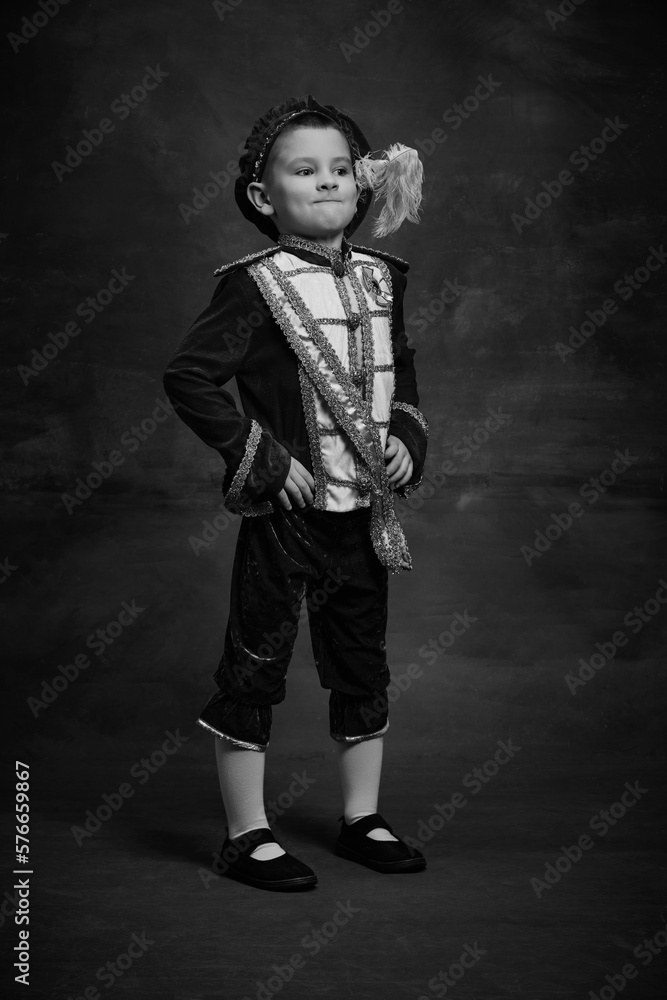 Obraz premium Black and white portrait of little boy dressed up as medieval character, little prince and pageboy. Retro fashion, emotions, theater art concept
