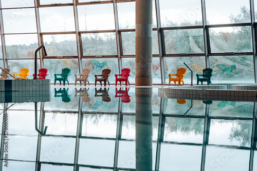 Swimming-Pool with equipment and large windows with a view outside