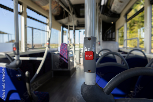 close up of a stop button inside a public transport vehicle, request to stop, background blur, selective focus