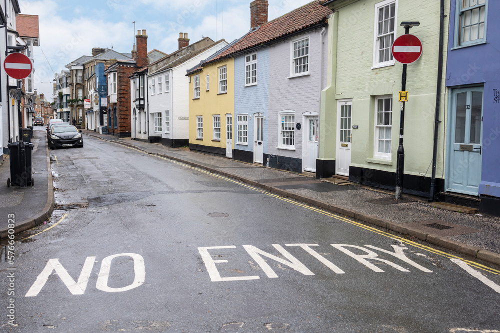 Southwold united kingdom 23, November 2022  A row of colourful terraced houses along a road with a bright red no entry sign in Southwold, Suffolk