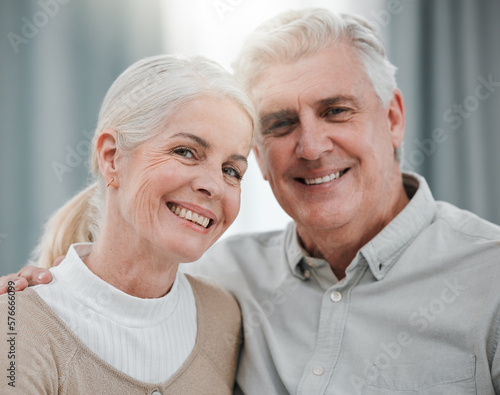 Portrait, love and lifestyle with a senior couple hugging in the living room of their house together. Smile, face or trust with a happy mature man and woman bonding while enjoying retirement at home