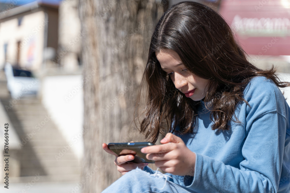Girl playing video games with a smartphone Girl playing video games with a smartphone