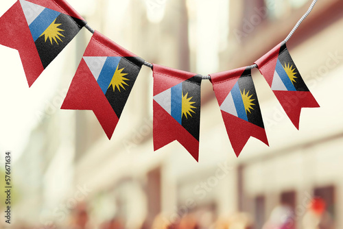 A garland of Antigua and Barbuda national flags on an abstract blurred background photo