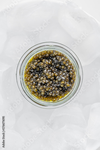Obraz na płótnie Premium caviar black in glass jar and ice cube w salonie