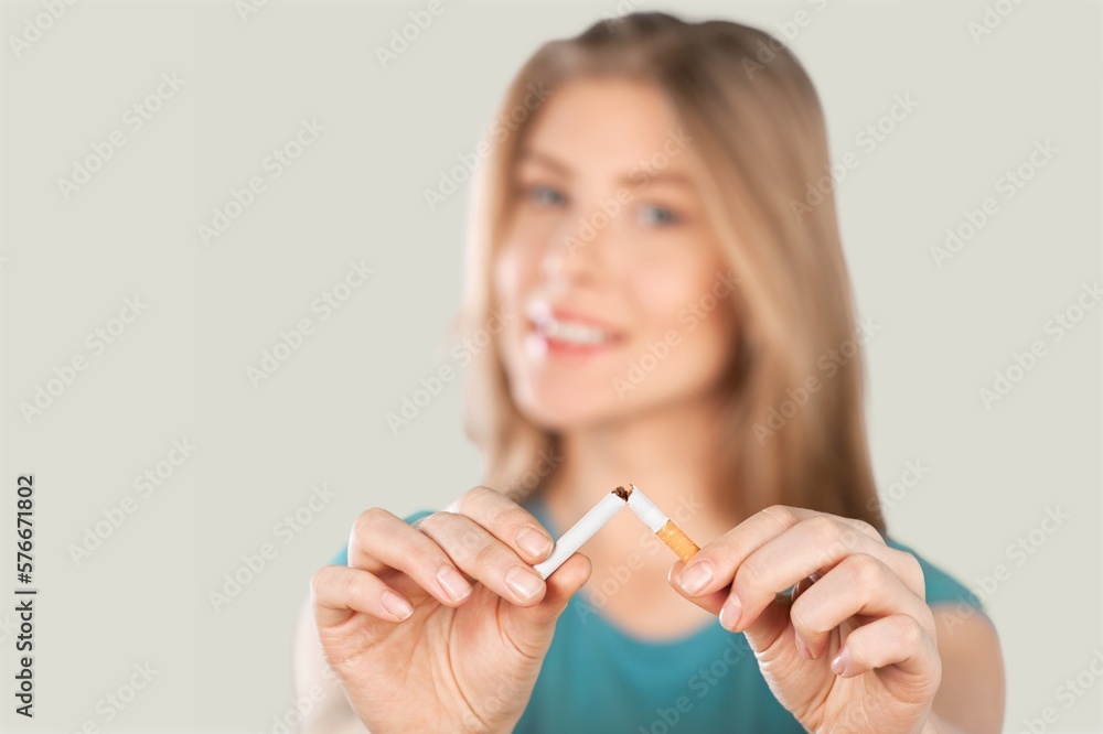 Stop smoking concept, young woman broken cigarette Stop smoking concept, young woman broken cigarette