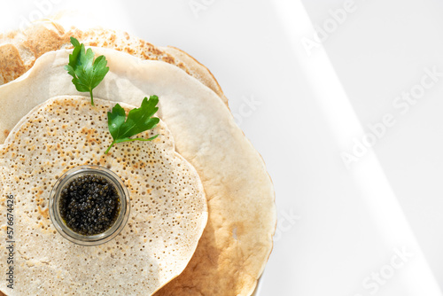 Obraz na płótnie served pancake with black caviar, parsley w salonie