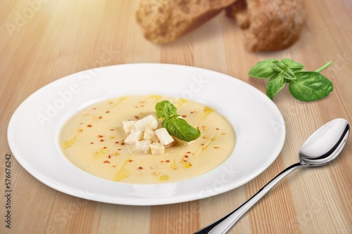 Tasty fresh soup dish in plate with bread