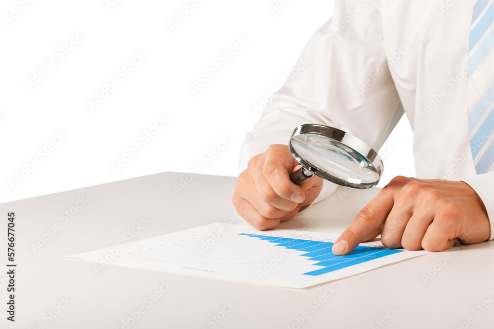 Fototapeta premium Reviewing results. Business with Magnifying Glass; and chart